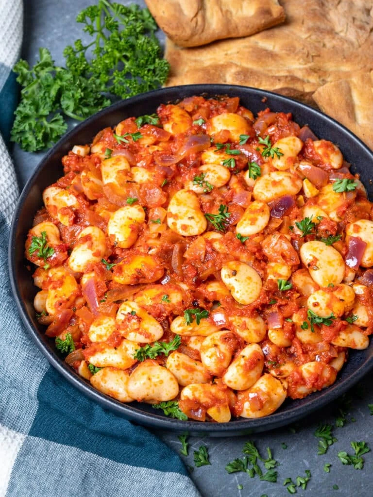 A dish of giant baked beans (gigantes plaki, the best Greek legume stew dish.