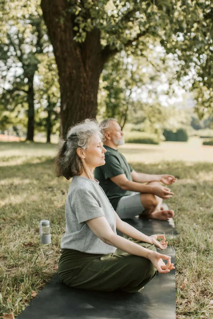 Elderly couple meditating for health & wellness