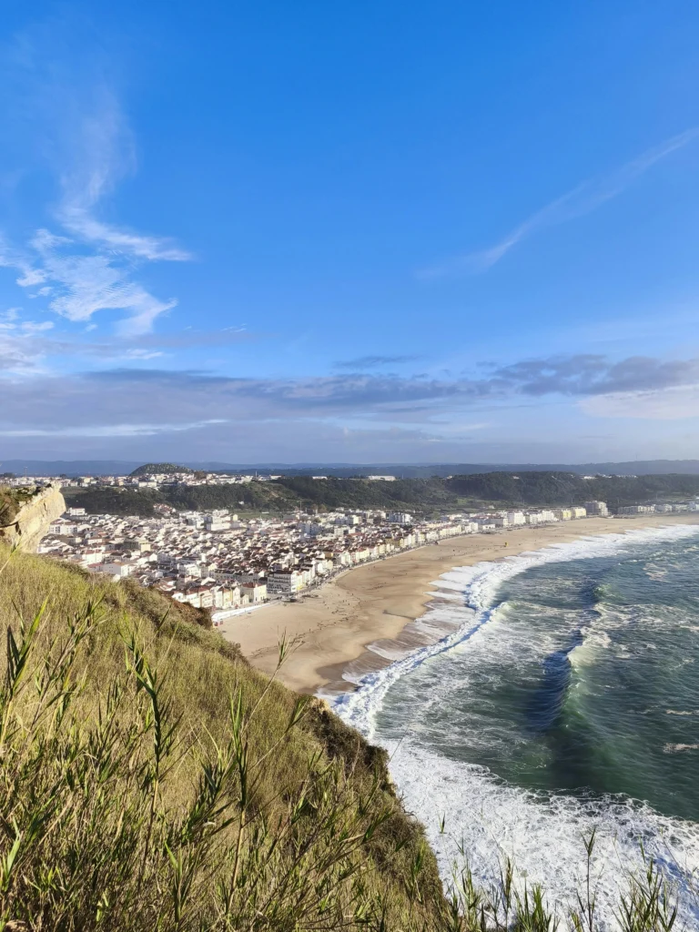 Aerial vie of coastal town and sandy beach that you can budget for plan-based travel.