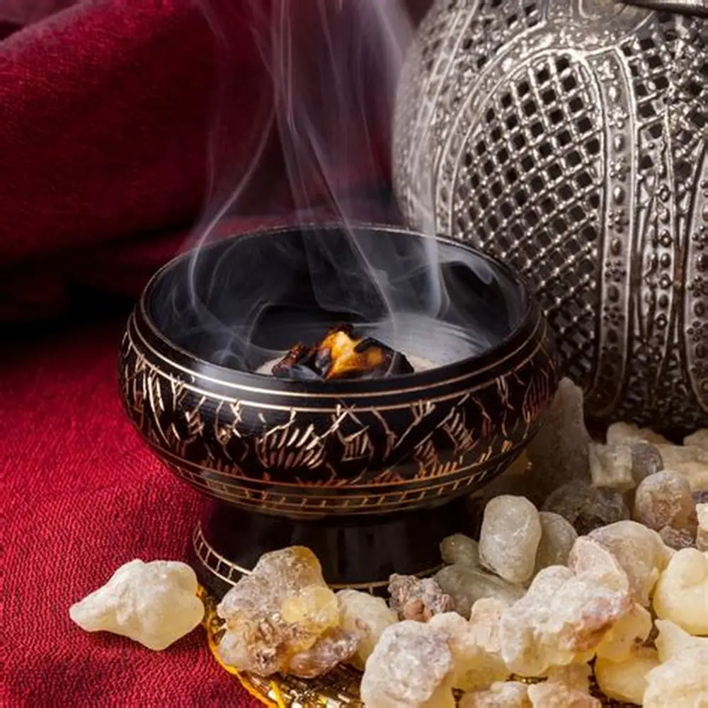 Frankincense on a bowl and myrrh on top of red cloth, the biblical herbs.